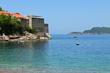 Fototapeta na wymiar Azure waters of beautiful Sveti Stefan beach. Montenegro