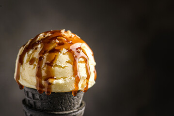 ice cream in a black cone with caramel
