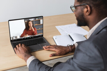 Online Meeting. Black male entrepreneur having video call with female business partner