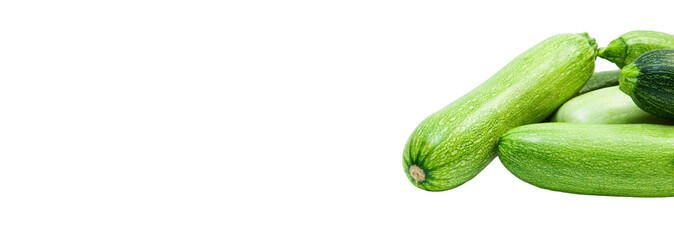 fresh zucchini on a white background. delicious green vegetables on the table. appetizing zucchini on a light texture. healthy food concept