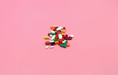 Set of pills, pills or medicines on a pink background