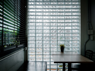 Glass brick wall background. Modern glass block wall with the light through decorated in the cafe...