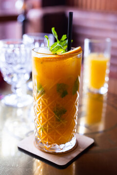 Non Alcoholic Sea Buckthorn Cocktail With Mint And Orange In A Glass Glass