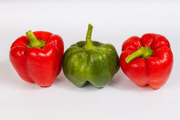 Two red green sweet peppers on a white background