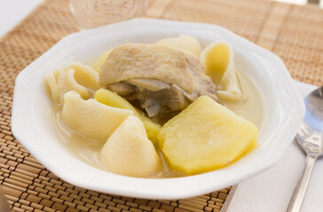 chicken broth soup with chicken, potatoes, and pasta shells