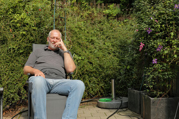 Fototapeta premium man sitting on a garden chair