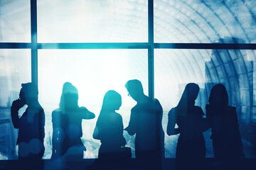 Silhouette of busy people stand near window