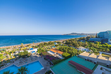 Fototapeta na wymiar Beautiful view of Mediterranean sea sand beach and hotel buildings on background. Rhodes. Greece. 