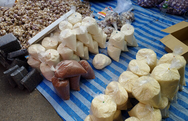 selling milled rice and garlic on street local market