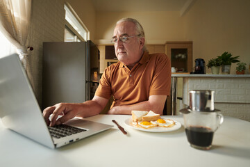 Elderly Man Eating Breakfast at Home