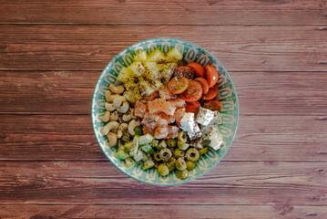 Homemade poke bowl with black Venus rice and salmon on a dark wooden table. Traditional Hawaiian...