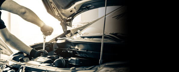 Close-up hand auto mechanic using the wrench to repairing car engine problem. Concepts of check and fix car and maintenance servicing.