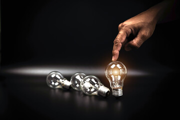 Close up hand choose light bulb or lamp for human resources or leadership and creativity thinking idea motivation or vision and knowledge learning and study or education concept.