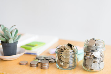  a coin in a glass bottle on wooden table, Investment business, retirement, finance , tax , emergency and saving money for future concept.