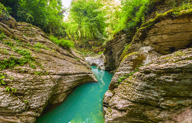 Mountain river with blue water.  Wet canyon of the Psakho river. - 524868121