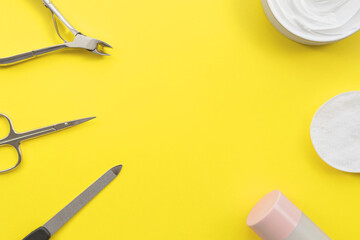 Set of manicure and pedicure tools on yellow background
