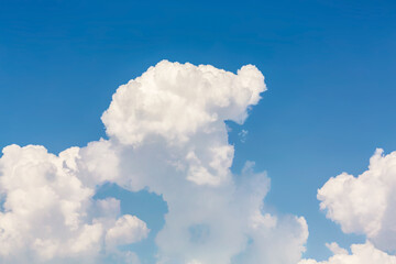 Fototapeta na wymiar Fluffy cumulus clouds in sunny day. Atmosphere background or wallpaper