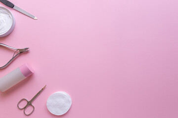 Set of manicure and pedicure tools on pink background