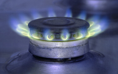 A dilapidated gas burner, burning with the last gas supply. Blue mood.