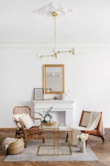 Fotobehang Boho Wicker armchairs against decorative fireplace in living room  © brizmaker