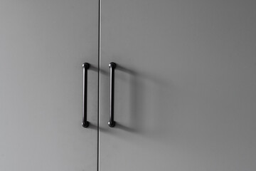 closeup of wood cupboard door and metal handle