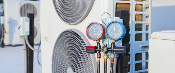 Air conditioner technician checking air conditioner operation