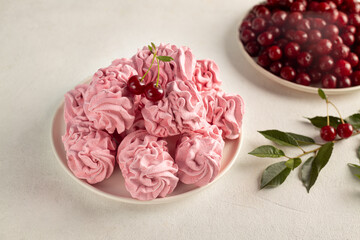 Tasty sweet zephyr and cherries on light background