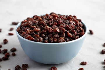 Dried Brown Raisins in a Bowl, side view.