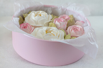 zephyr bouquet of flowers in a pink box on a light background