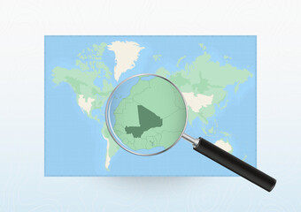Map of the World with a magnifying glass aimed at Mali, searching Mali with loupe.