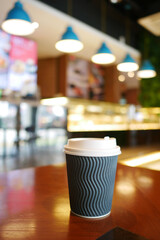 take away paper coffee cup o on cafe table