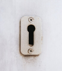 Antique keyhole on an old wooden door. Vintage lock symbol. Exit or solution concept. Problem solving.