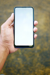 Close up of young man hand using smart phone with green screen 