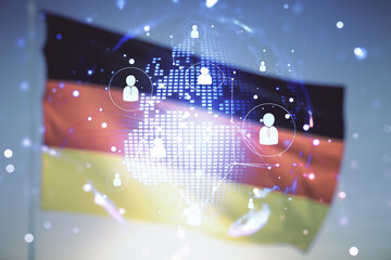 Virtual social network hologram and world map on flag of Germany and sunset sky background. Multiexposure