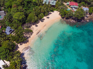Aerial view from drone of Top Soleil beach at Mahé Island taken in the afternoon light above the ocean