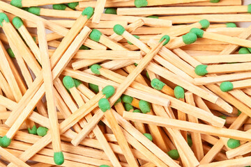 Background of randomly scattered matches with green heads