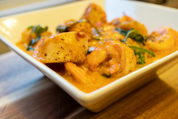 Shrimp and Grits (Polenta) with Scallops in a Tomato Based Sauce with Spinach and Basil