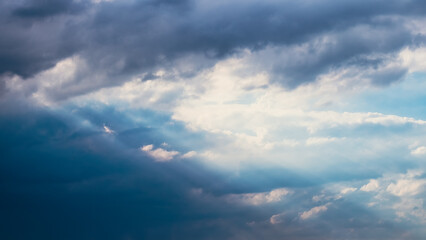 Sun beams or light rays breaking through the clouds.