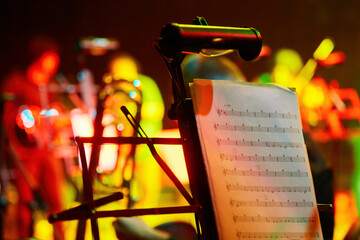Music stands on stage in a symphony orchestra. Sheet music for a musician. The concept of culture...
