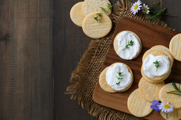 Delicious crackers with cream cheese and rosemary on top. Cookies with cream cheese