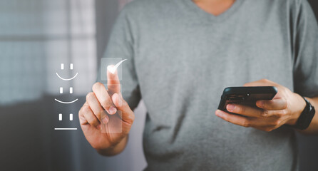 Businessman pressed the smiley face emoticon on the virtual touch screen rated the service quality excellent. Customer Service Assessment Concept