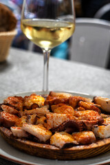 Pulpo a Feira, or Octopus of the Camino de Santiago, with a glass of white wine