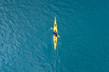 Kayak boat blue turquoise water sea, sunny day. Concept banner travel, aerial top view