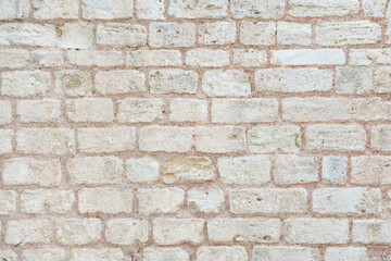 Photo of old brick wall. Beige background, texture of big brick wall.