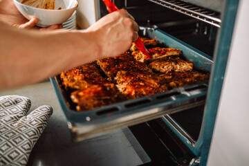 oven grilled chicken legs with a delicious curry sauce served on a baking tray 