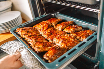 oven grilled chicken legs with a delicious curry sauce served on a baking tray 