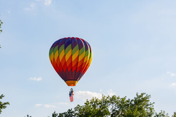 Hot air balloon flying with an American flag
