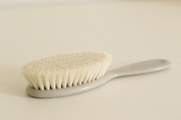 soft grey baby comb on white table