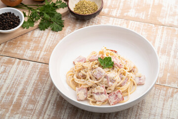 Homemade spaghetti white cream sauce with ham in white plate.Italian food style