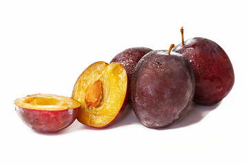 Freshly picked several round plums with white background